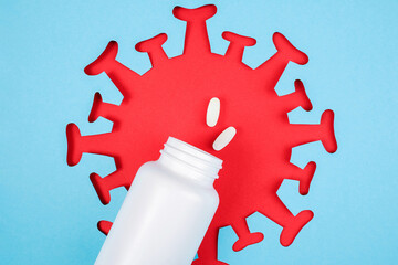Two pills fly out from medical bottle. Dietary supplements, antibiotic, painkillers and red...