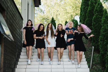 Beautiful sexy young girls in dress and veil on bachelor party. Bride and bridesmaids walking outdoors and celebrating bachelorette party. Maiden evening, Hen-parties. Place for text.