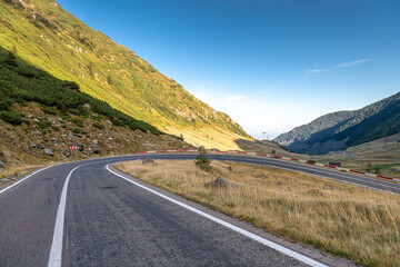 Transfagarasan road in Romania - curved amazing motorway through the mountains from Transylvania in a cloudy day with spectacular sky