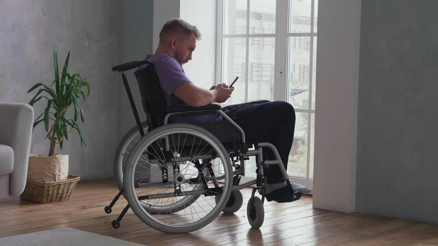 Man using cell phone on wheelchair