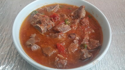 A close up view of stewed chicken meat cubes with spices on it