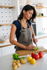 Beautiful young woman cooking in the kitchen. Healthy, organic, food concept