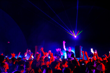 Crowd and DJs dancing during party
