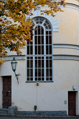 Fototapeta na wymiar A lantern and a tall window of an old house