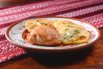 Delicious meat piece with cut baked potatoes. Tasty dinner concept. Traditionla Ukrainian cuisine Ukrainian meal concept