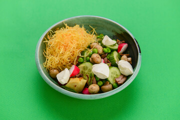 Sauteed mushrooms with cucumbers, radish and cheese in a salad. Delicious healthy eating concept.