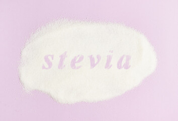 Inscription Stevia sugar substitute for diabetics on scattered stevia on a pink background