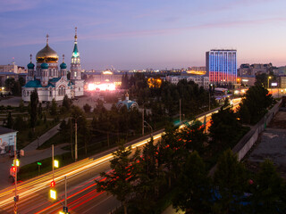 Assumption Cathedral in Omsk from a height, Internatsionalnaya street, the building of the Ministry of Economics and Education with evening illumination.