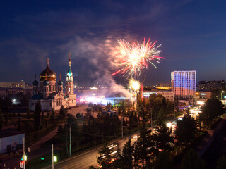 Fireworks over the Assumption Cathedral in Omsk. Festive fireworks in Omsk near the Assumption Cathedral and the government of the Omsk region.