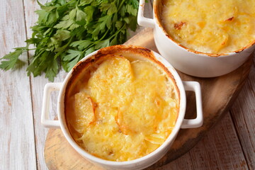 Potato gratin in baking white cocotte