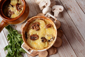 Potato gratin with mushrooms in baking cocottes