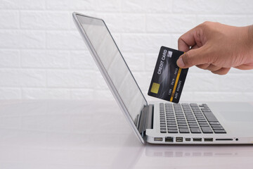 Close up of hands  using laptop and credit  card in hand free from copy space .shopping/paying...