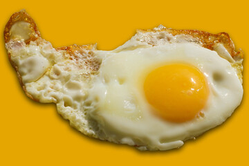Single fried egg isolated on yellow background.