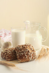 Fresh baked garlic buns and milk on white table
