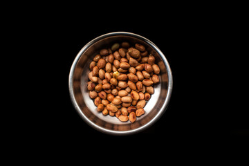 steel dish full of indian food peanuts