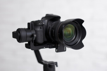 photography or videography kit - close up of modern dslr camera on 3-axis gimbal stabilizer over...