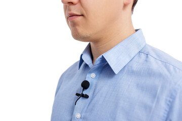 sound recording concept - close up of small lavalier microphone on male shirt