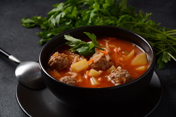 Patatesli Sulu Kofte - Turkish soup with meatballs in white bowl.