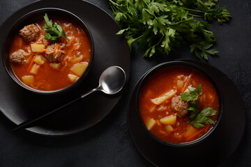 Patatesli Sulu Kofte - Turkish soup with meatballs in white bowl.