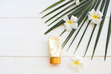 natural cosmetics sunscreen spf50 health care for skin face of lifestyle woman relax summer and flower frangipani ,coconut leaf arrangement flat lay  style on background white 
