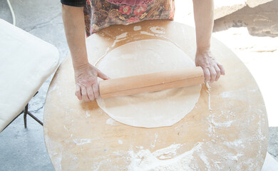 Woman preparing armenian bread lavash.