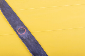 yellow background in retro style. On it lies a camera with a sealed hole.