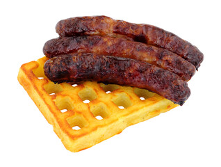 Grilled pork sausages on a potato waffle isolated on a white background
