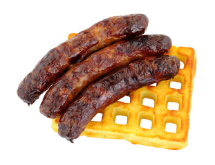 Grilled pork sausages on a potato waffle isolated on a white background