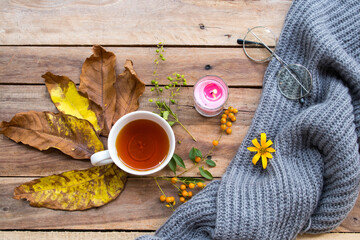  herbal healthy drinks hot lemon tea for health care cough sore with flowers ,yellow leaves and knitting wool scarf of lifestyle in autumn season arrangement flat lay style on background wooden