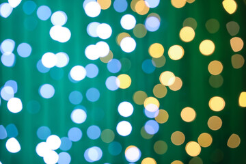Blurred Christmas lights on color background