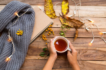 hand of girl holding herbal healthy drinks hot lemon tea for health care cough sore with flowers...