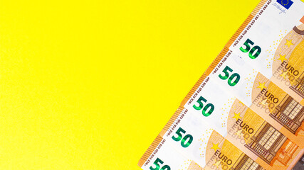 Fragment of the 50 fifty euro banknote on a yellow background. Close up currency money.