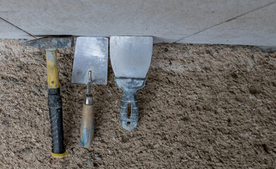 Bricklayer tools against the wall