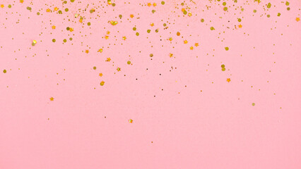 Gold glitter on pink background. Holiday abstract