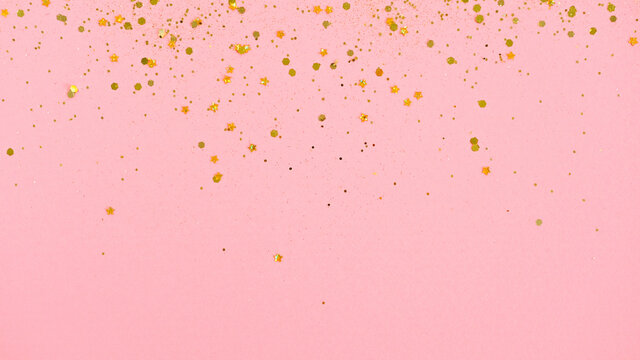 Gold glitter on pink background. Holiday abstract