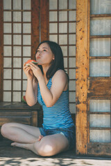 Fototapeta premium Summer watermelon and sweet girl in Japanese Garden
