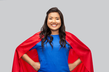 women's power and people concept - happy asian woman in red superhero cape over grey background © Syda Productions