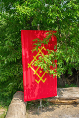 On the trident is a red banner with a yellow Scandinavian ornament.