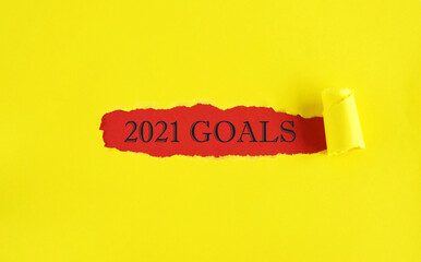 Word 2021 Goals on torn yellow paper background. new year 2021 resolution, setting up goals, targets to achieve concept