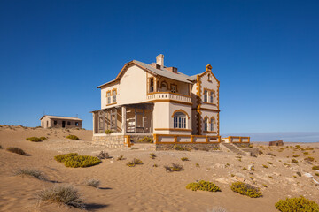 Abandoned colonial house in Kolmanskop ghost-town in the Namib desert in namibia