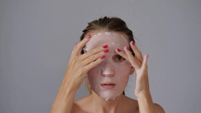 Korean cosmetic facial mask moisturizing, nutrition, hyaluronic acid, acne removal. Spa treatment face massage at home.