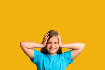 Stressed out child. Problem crisis. Mistake regret. Despair frustration. Portrait of confused young girl in blue suffering from headache with closed eyes isolated on orange copy space background.