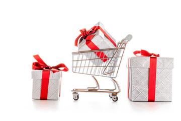 Christmas shopping. Trolley cart for supermarket with christmas or birthday gift box isolated on white background. Sale buy mall market shop consumer concept. Copy space.