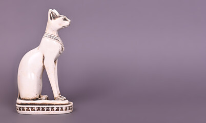 The Egyptian God in the form of a cat, a statuette of an animal on a gray background.
