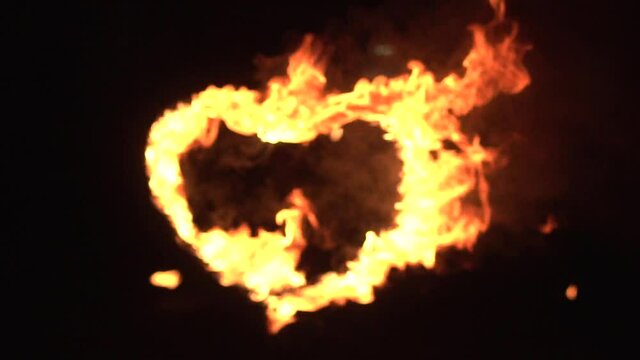 Burning heart is burning with fire at night on holiday, background, slow motion