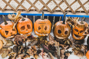 carved pumpkins with different faces are resting on a halloween party