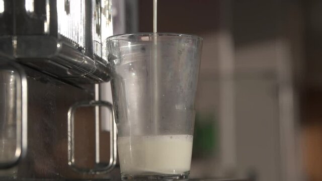4K close-up video Making of a latte macchiato coffee drink on a special espresso machine
