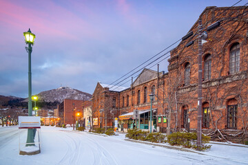 Cityscape of the historic red brick warehouses  at twilight in Hakodate Hokkaido Japan in winter - obrazy, fototapety, plakaty