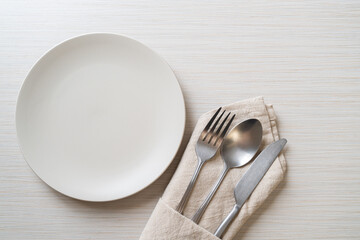 empty plate or dish with knife, fork and spoon