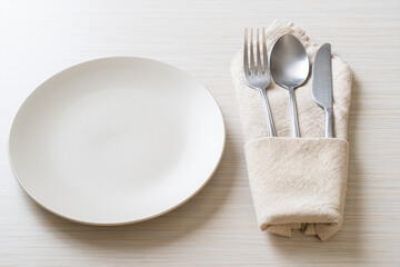 empty plate or dish with knife, fork and spoon